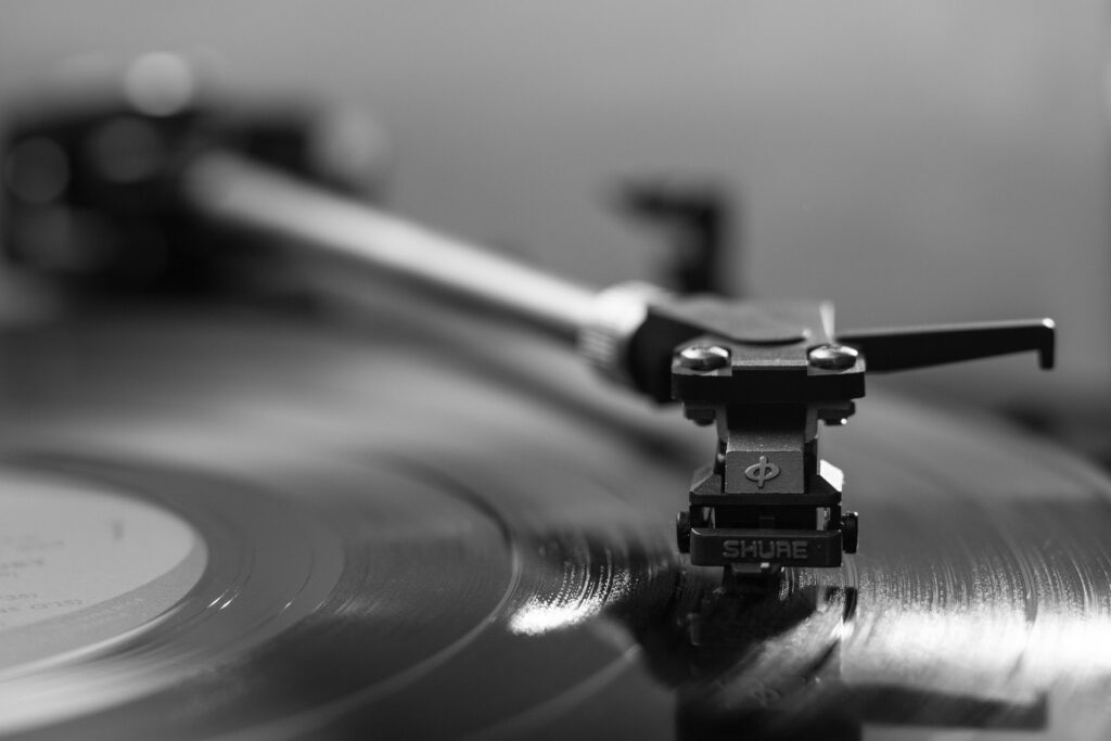 pexels-photo-145707-145707 Black and white close-up of a turntable playing a vinyl record, emphasizing vintage aesthetics.